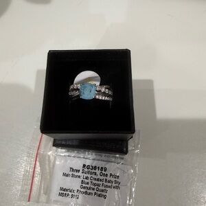 Three Suitors, One Prize Blue Topaz Silver Ring